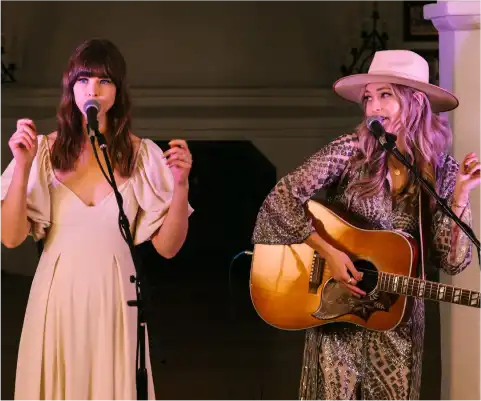 Women on stage singing song