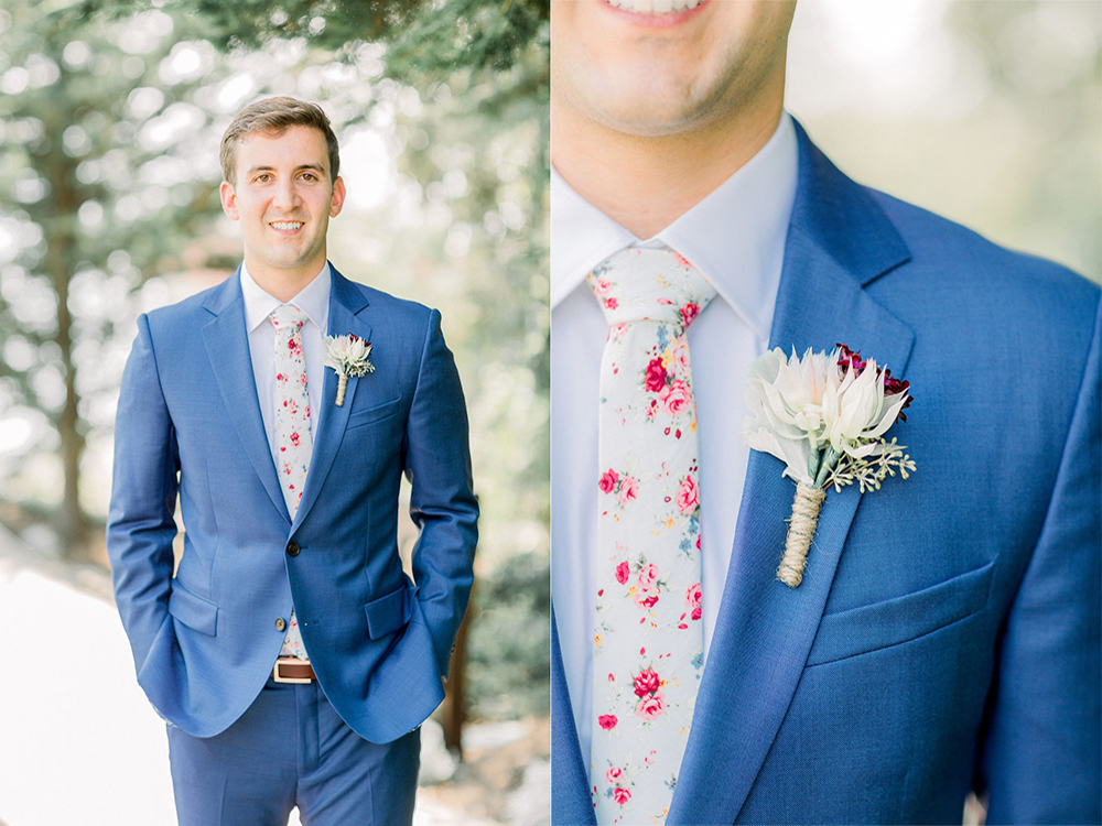 Groom with blue linene suit, white shirt, and floral tie