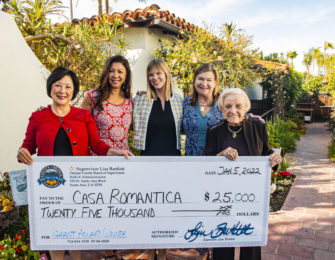 Casa Romantica Leadership team holding large check