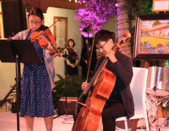 Boy and Girl playing the violin and chello on stage